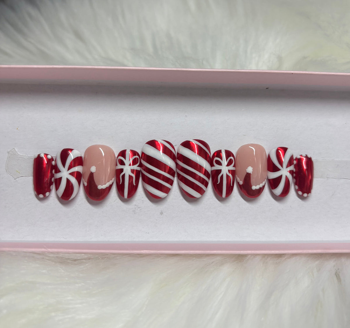 red chrome christmas candy cane ribbon gift bow santa hat peppermint holiday press-on nails by Polished by Maddie